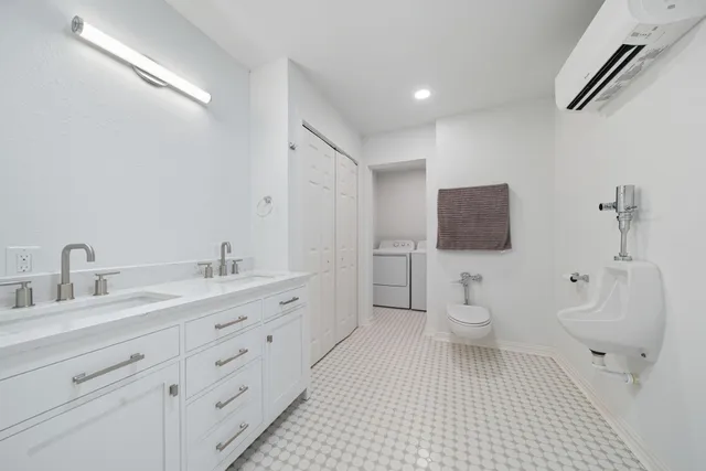 a bathroom with a toilet sink a mirror and shower