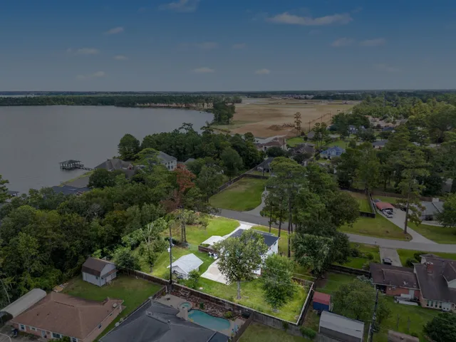 an aerial view of a houses with a yard