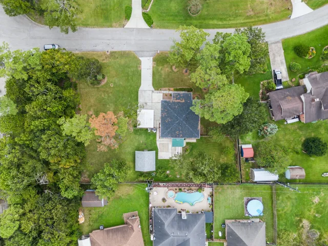 an aerial view of a house with a yard