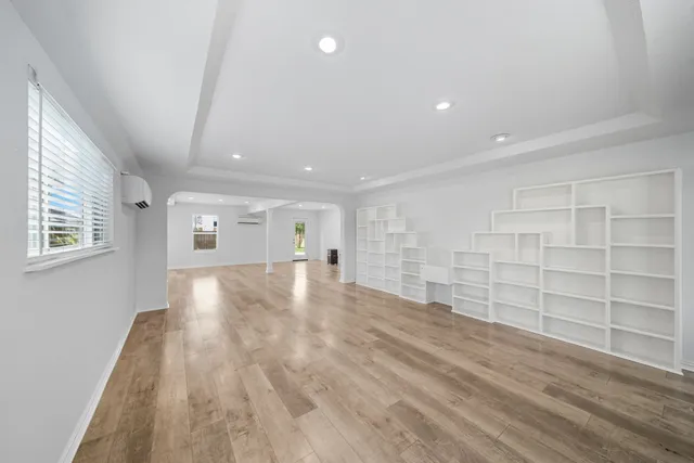 a view of empty room with wooden floor and cabinet