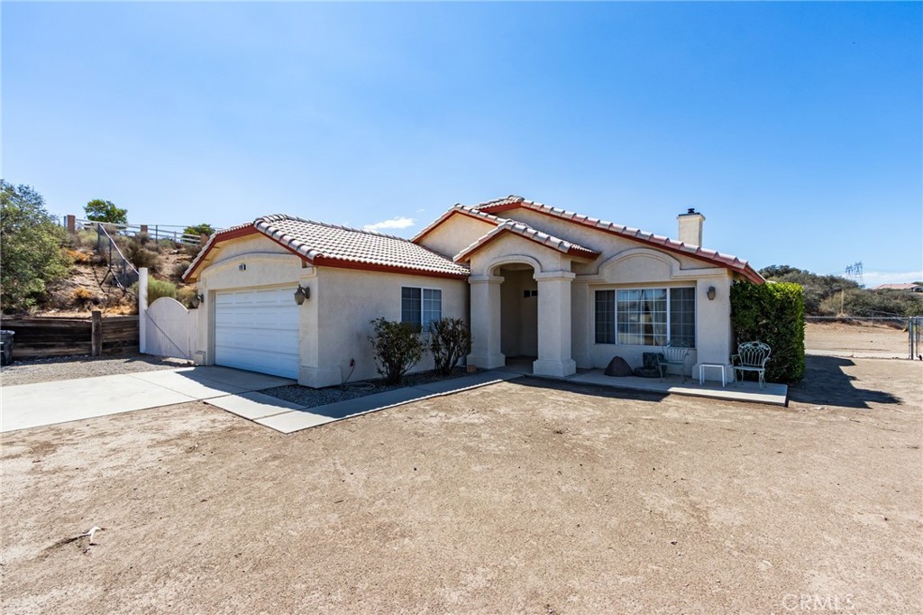 7170 Joshua Road Oak Hills, CA 92344 - Photo 16 of 58 a front view of a house with a yard