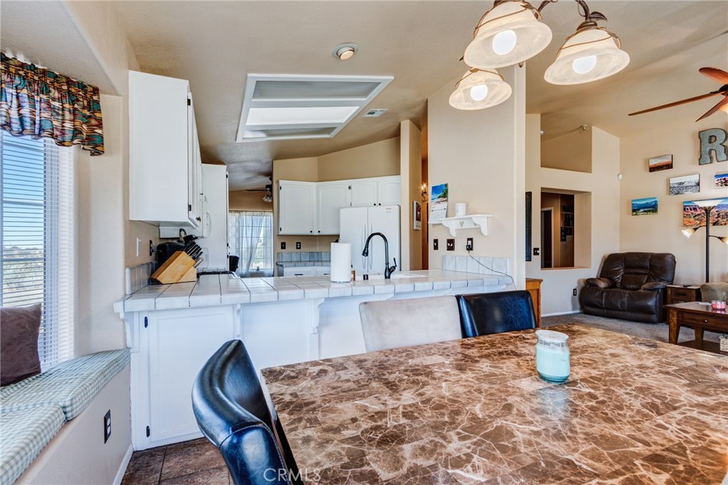 7170 Joshua Road Oak Hills, CA 92344 - Photo 28 of 58 a kitchen with stainless steel appliances granite countertop a sink and cabinets