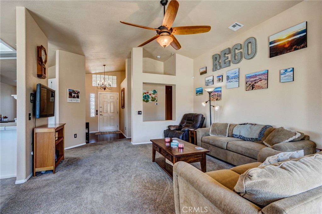 7170 Joshua Road Oak Hills, CA 92344 - Photo 34 of 58 a living room with furniture and a chandelier