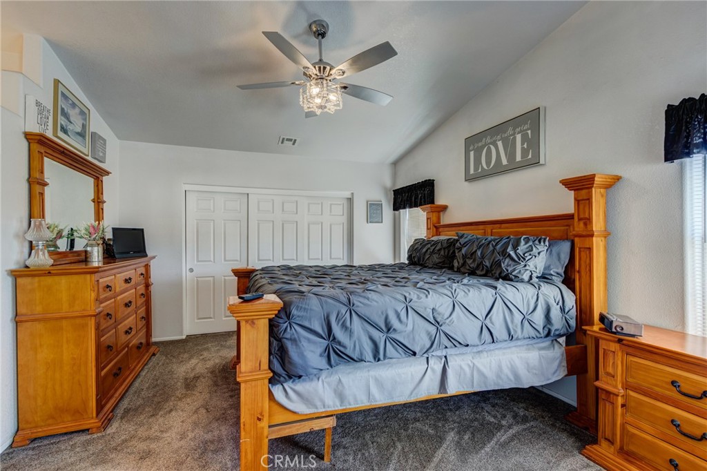 7170 Joshua Road Oak Hills, CA 92344 - Photo 36 of 58 a bedroom with a bed and wooden floor