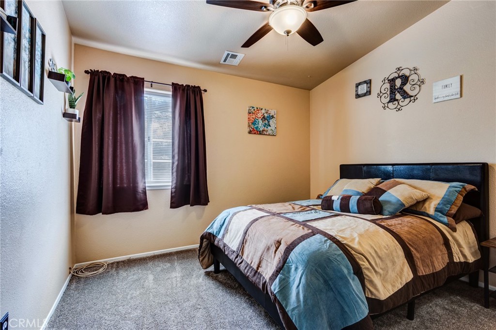 7170 Joshua Road Oak Hills, CA 92344 - Photo 49 of 58 a bedroom with bed and window