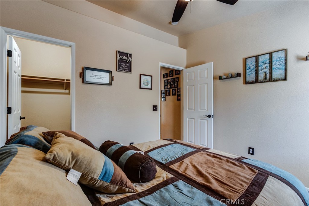 7170 Joshua Road Oak Hills, CA 92344 - Photo 50 of 58 a bedroom with bed and furniture