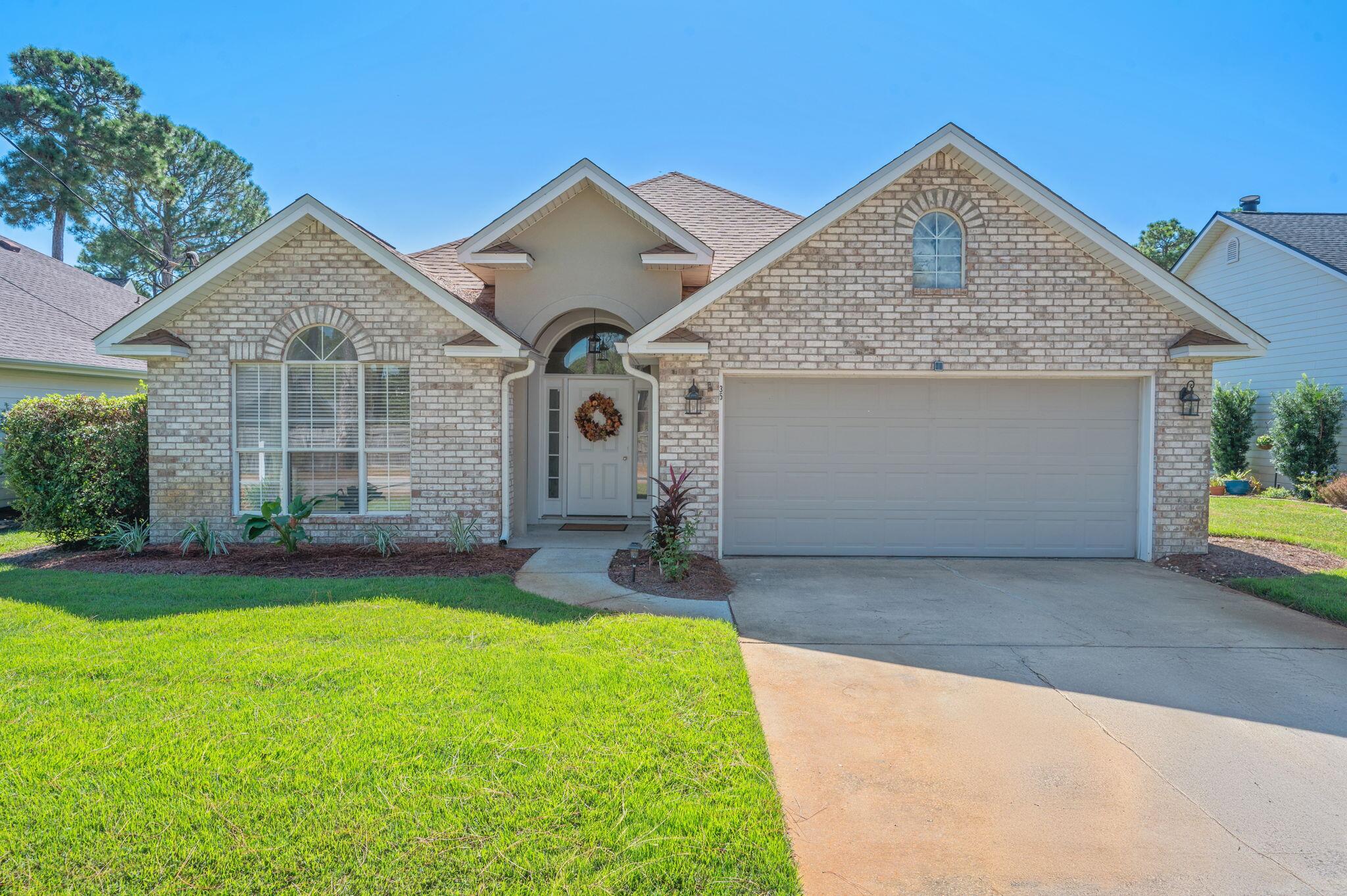 35 Lake Front Drive Miramar Beach, FL 32550 - Photo 1 of 29 a front view of a house with a yard and garage