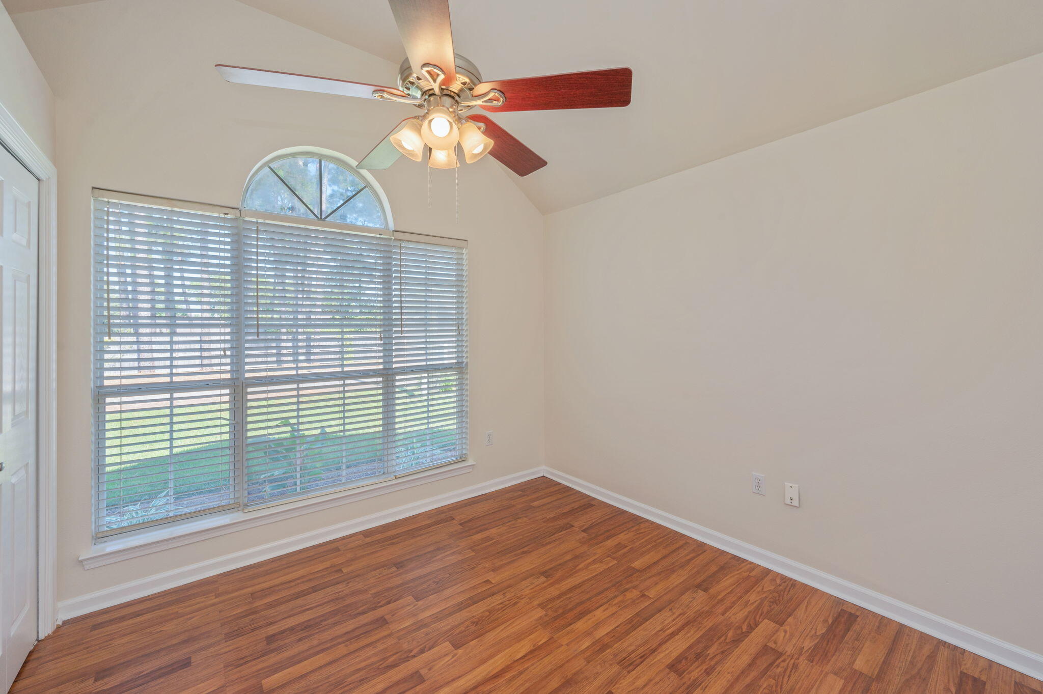 35 Lake Front Drive Miramar Beach, FL 32550 - Photo 19 of 29 an empty room with wooden floor fan and window