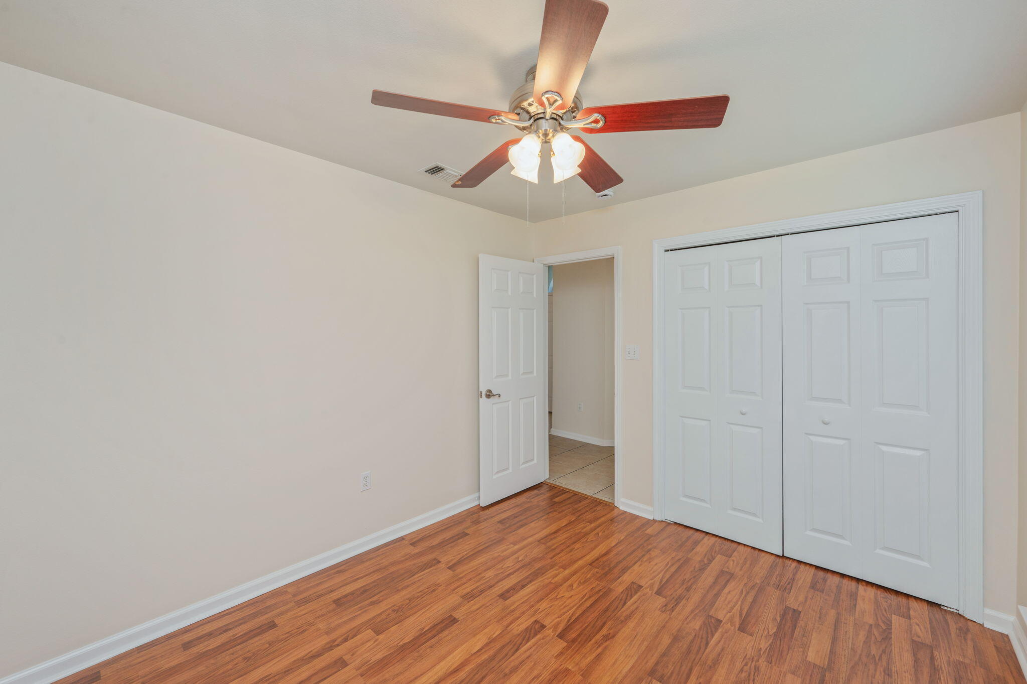 35 Lake Front Drive Miramar Beach, FL 32550 - Photo 22 of 29 a view of an empty room with wooden floor and a ceiling fan