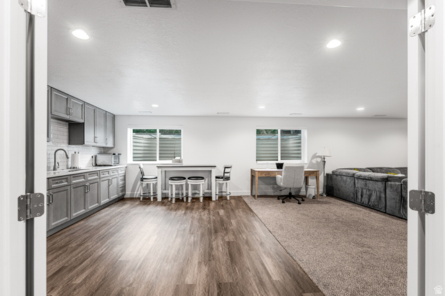 313 Old Maple Road South Weber, UT 84405 - Photo 18 of 35 Open-concept living space featuring wood-finish flooring, recessed lighting, and a full kitchen with gray cabinetry