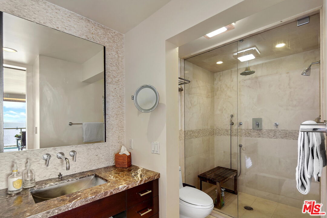 2 Ketch Street, Unit 102 Marina del Rey, CA 90292 - Photo 11 of 22 a spacious bathroom with a granite countertop sink mirror toilet and shower