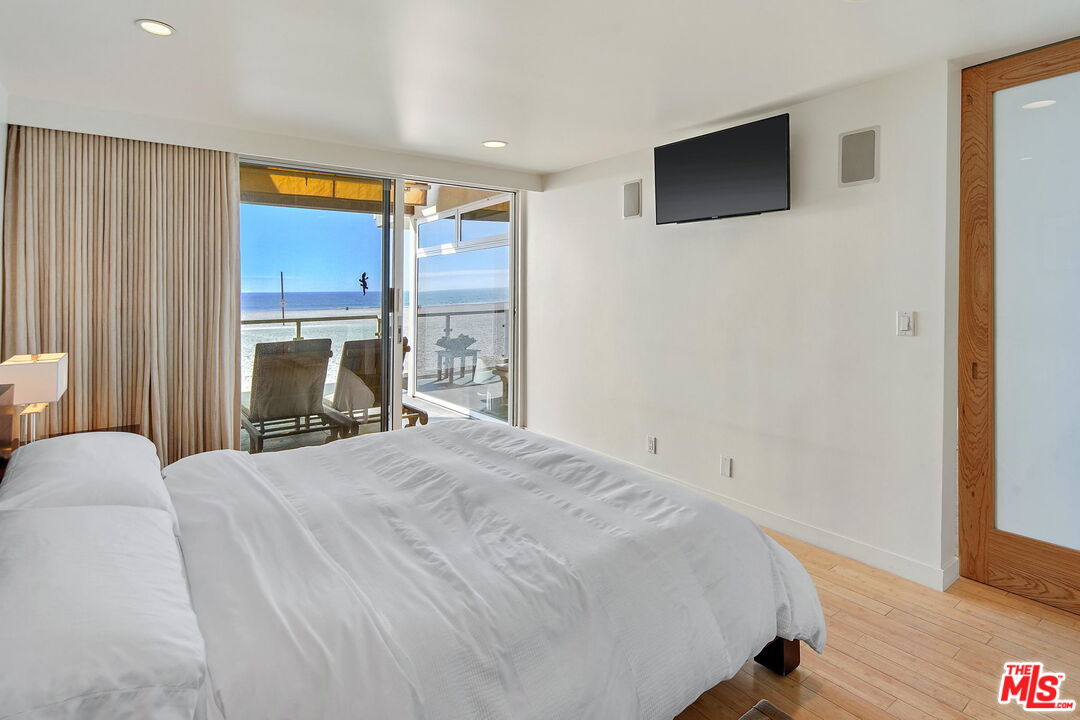 2 Ketch Street, Unit 102 Marina del Rey, CA 90292 - Photo 12 of 22 a bedroom with a bed and a flat screen tv
