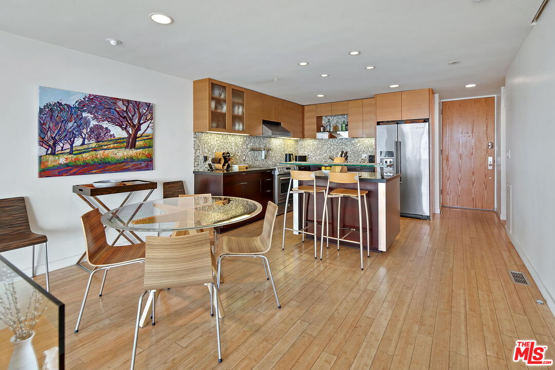 2 Ketch Street, Unit 102 Marina del Rey, CA 90292 - Photo 21 of 22 a view of a dining room with furniture wooden floor and a rug