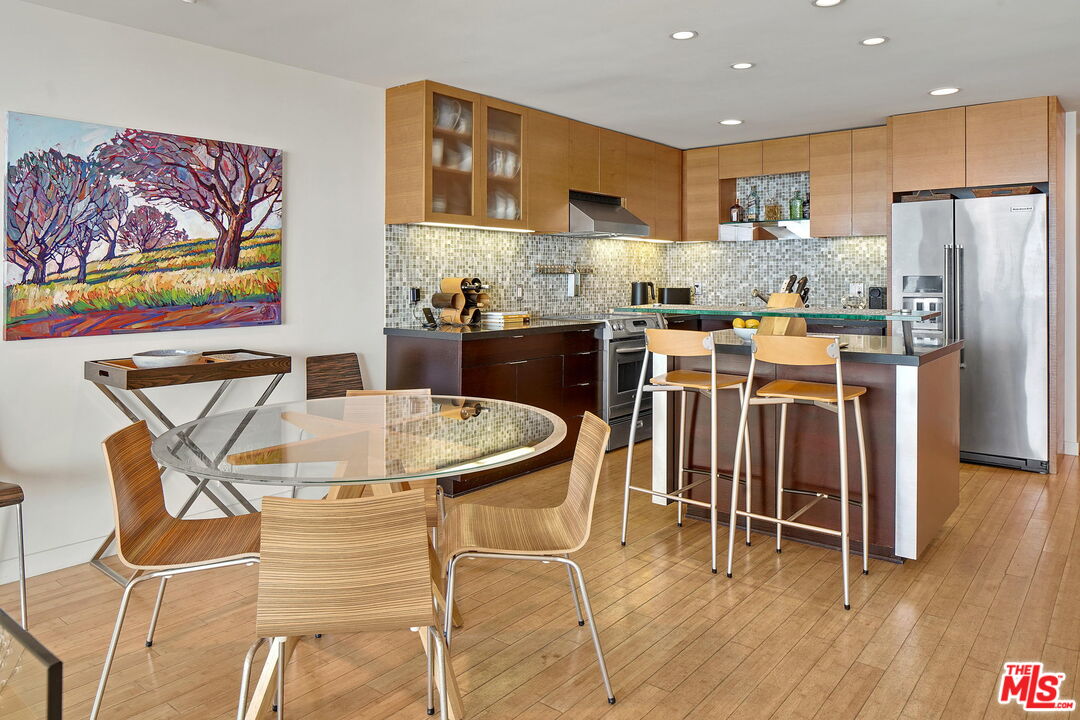 2 Ketch Street, Unit 102 Marina del Rey, CA 90292 - Photo 22 of 22 a kitchen with stainless steel appliances kitchen island granite countertop a table and chairs