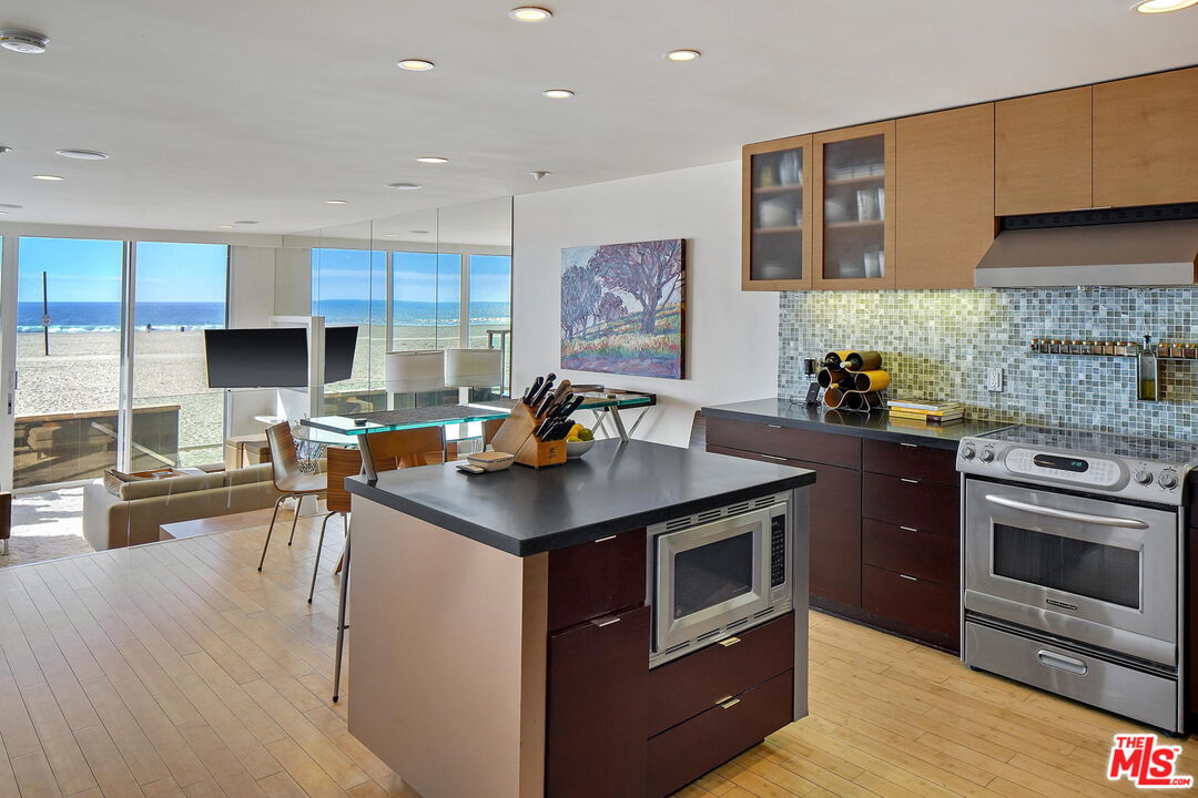 2 Ketch Street, Unit 102 Marina del Rey, CA 90292 - Photo 4 of 22 a kitchen with stainless steel appliances a stove a sink a microwave a stove and a refrigerator