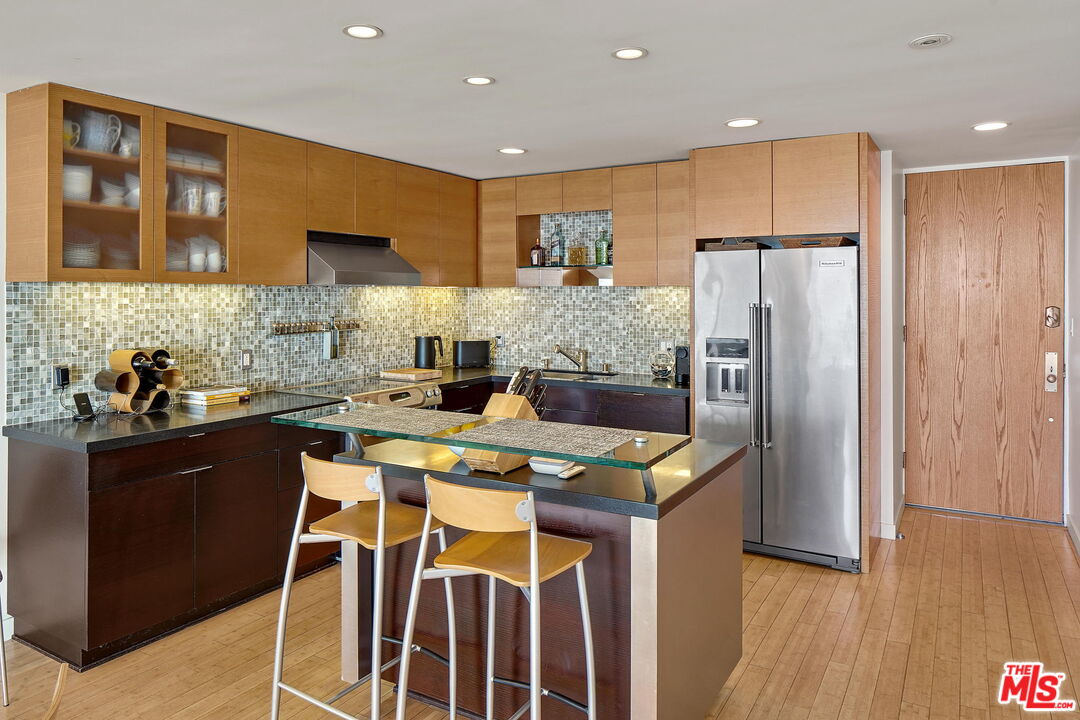 2 Ketch Street, Unit 102 Marina del Rey, CA 90292 - Photo 5 of 22 a kitchen with stainless steel appliances granite countertop a refrigerator and a stove top oven