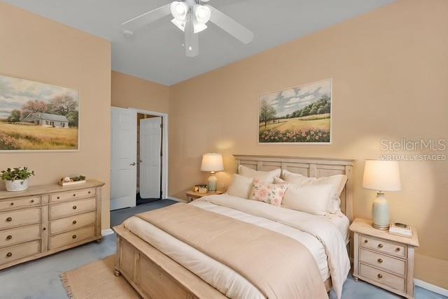 24088 Buckingham Way Punta Gorda, FL 33980 - Photo 13 of 37 a bedroom with a bed and a lamp on dresser