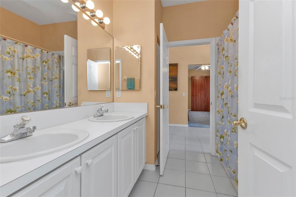 24088 Buckingham Way Punta Gorda, FL 33980 - Photo 14 of 37 a bathroom with a sink vanity and a mirror