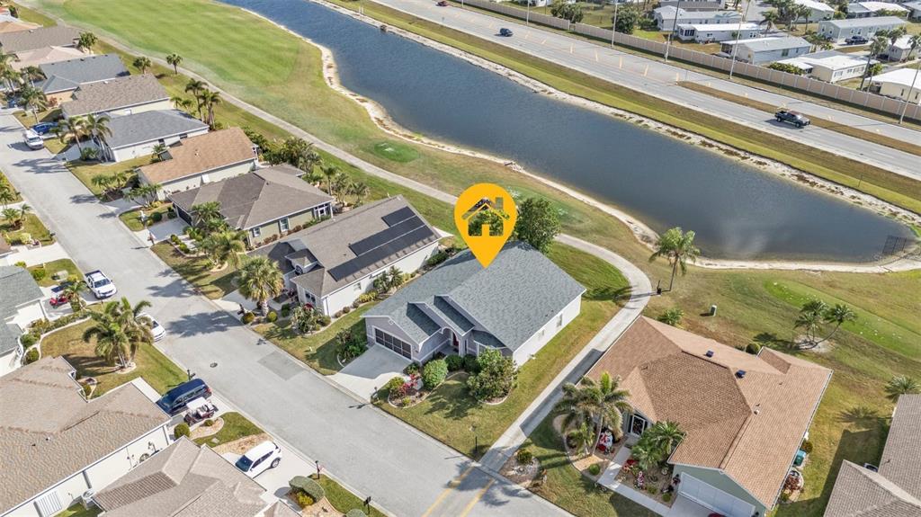 24088 Buckingham Way Punta Gorda, FL 33980 - Photo 15 of 37 an aerial view of a residential apartment building with a yard
