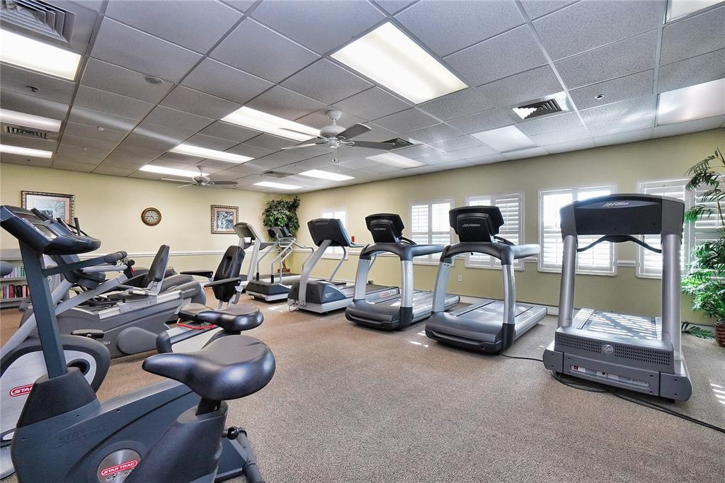 24088 Buckingham Way Punta Gorda, FL 33980 - Photo 35 of 37 a room with gym equipment and mirrors