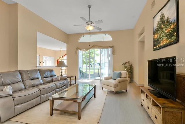 24088 Buckingham Way Punta Gorda, FL 33980 - Photo 5 of 37 a living room with furniture a flat screen tv and a large window