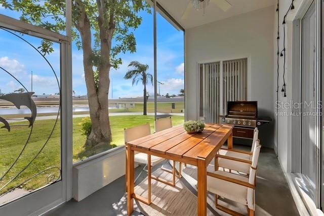 24088 Buckingham Way Punta Gorda, FL 33980 - Photo 6 of 37 a view of a dining room with furniture a chandelier and wooden floor