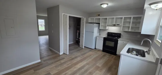 a kitchen with a refrigerator and a sink