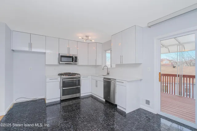 a kitchen with cabinets appliances and a window