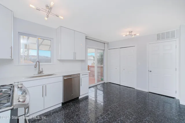 a kitchen with a sink cabinets and window