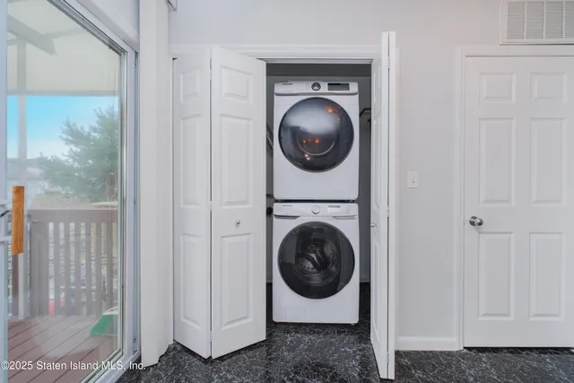 a view of a hallway with washer and dryer