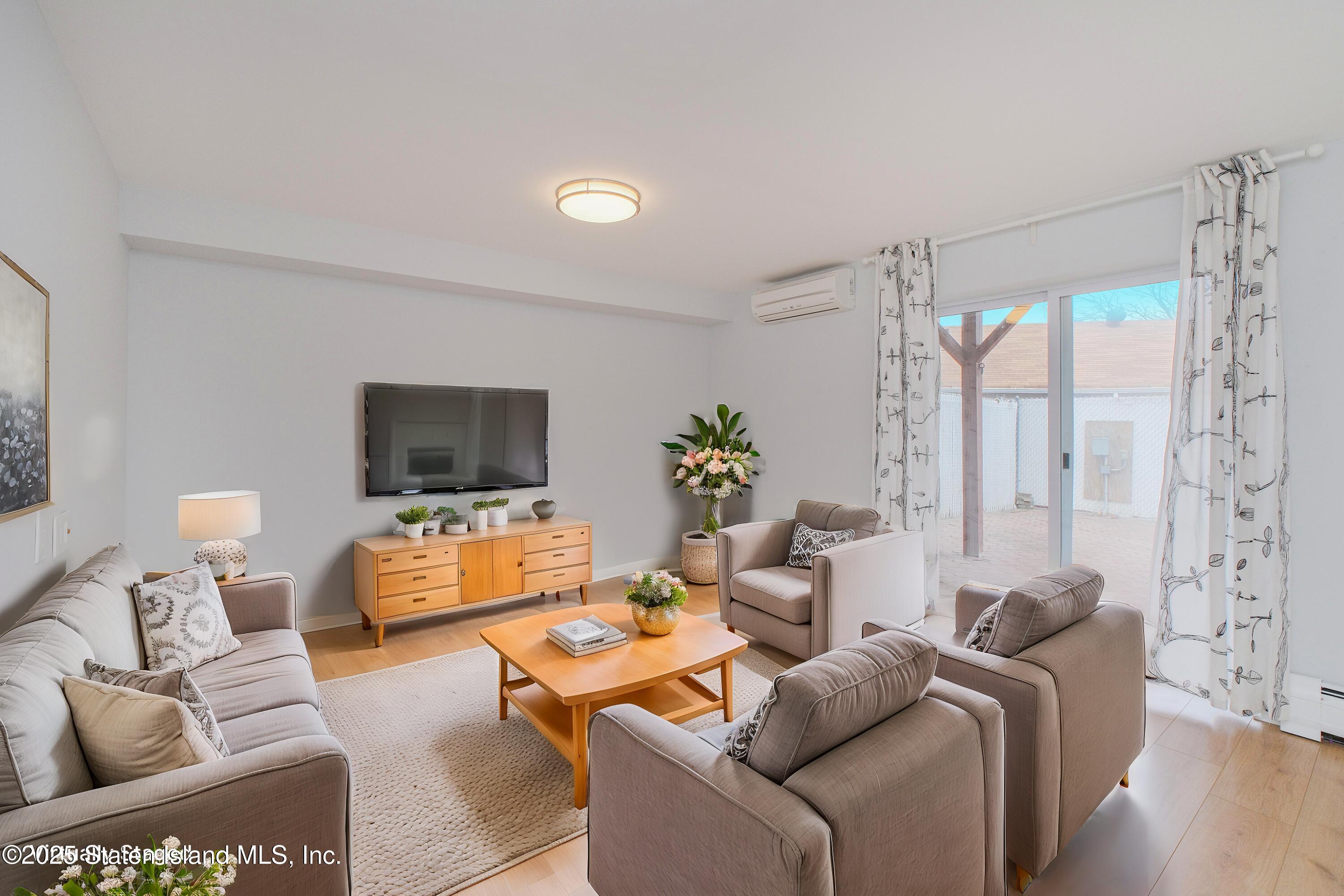 14 Ragazzi Lane Staten Island, NY 10305 - Photo 29 of 40 a living room with furniture a flat screen tv and a large window