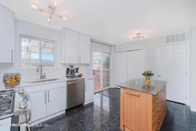 a kitchen with stainless steel appliances a sink stove and refrigerator
