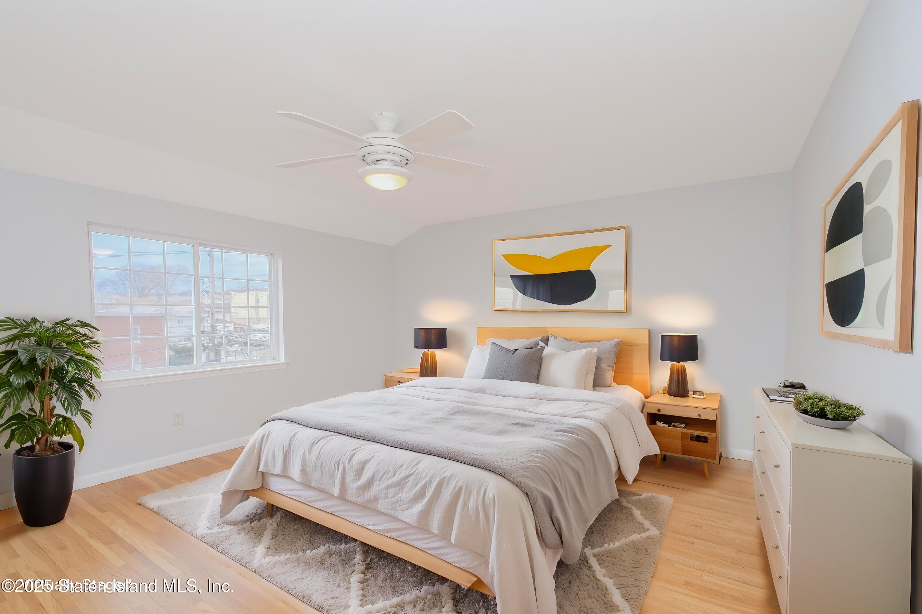 14 Ragazzi Lane Staten Island, NY 10305 - Photo 34 of 40 a bedroom with a bed and a potted plant