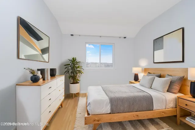 a bedroom with a large bed and a dresser