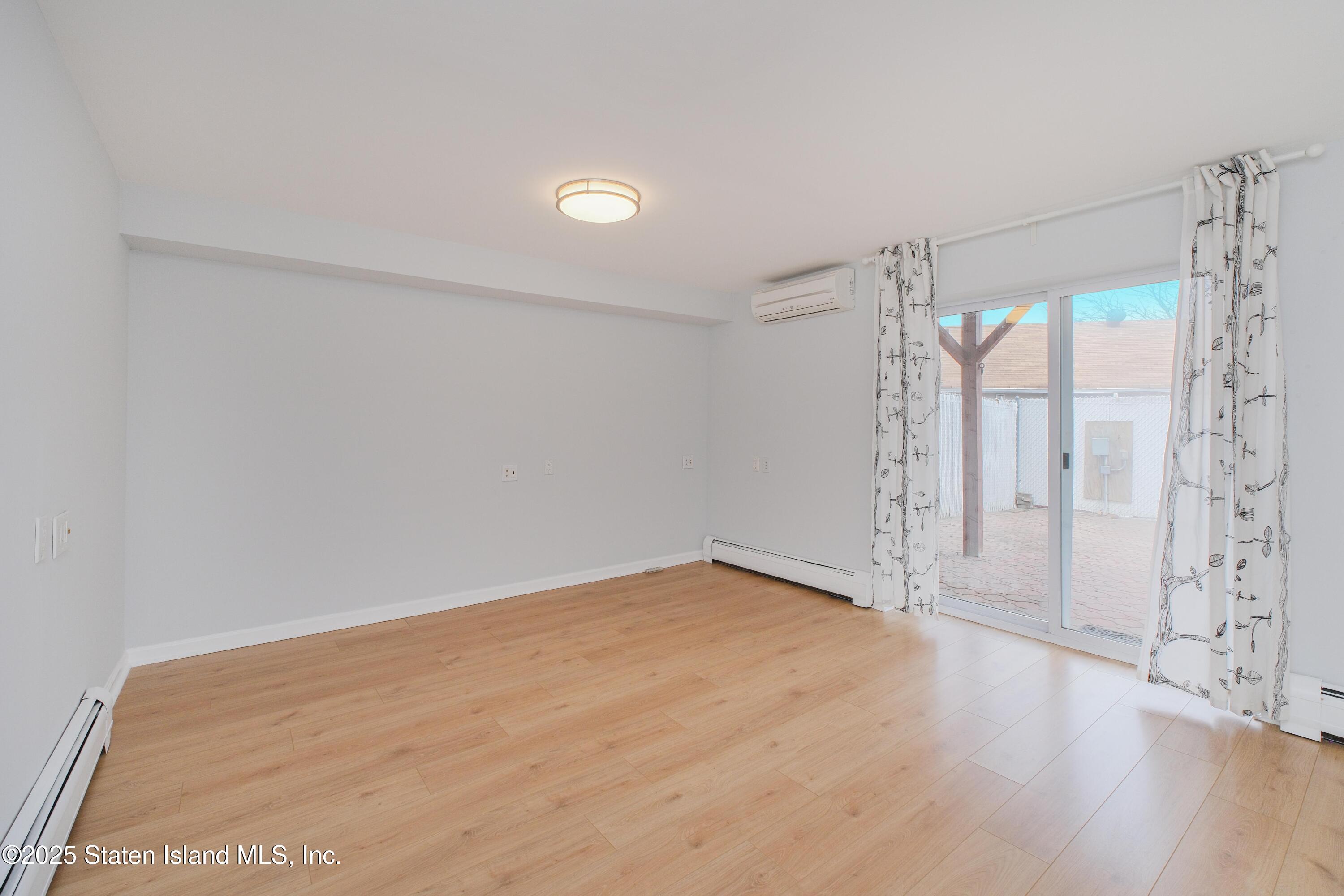14 Ragazzi Lane Staten Island, NY 10305 - Photo 5 of 40 a view of an empty room with wooden floor and a window