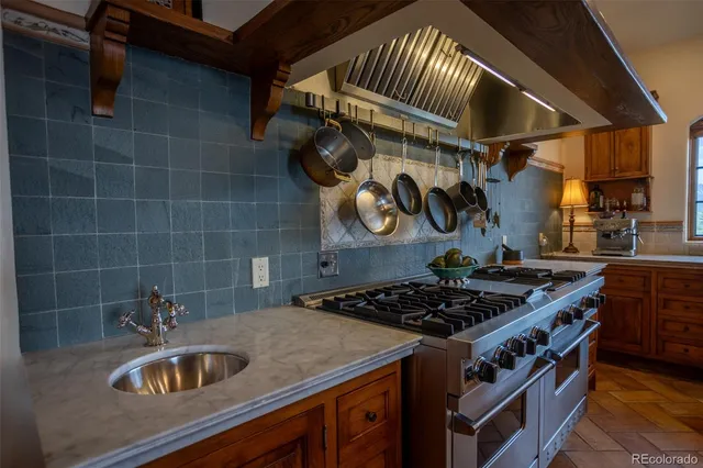 a kitchen with stainless steel appliances granite countertop a sink and a cabinets