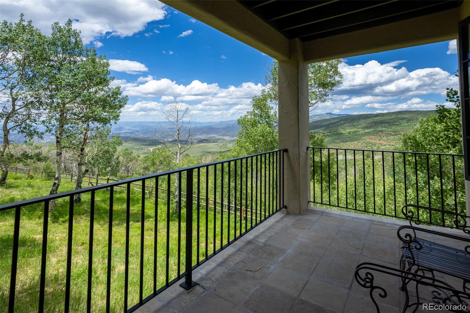 6903 Bellyache Ridge Road Wolcott, CO 81655 - Photo 25 of 50 a view of a porch with a floor to ceiling window next to a yard