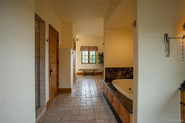 a spacious bathroom with a window double vanity and a mirror