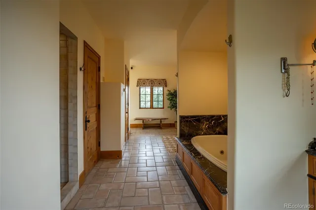 a spacious bathroom with a window double vanity and a mirror