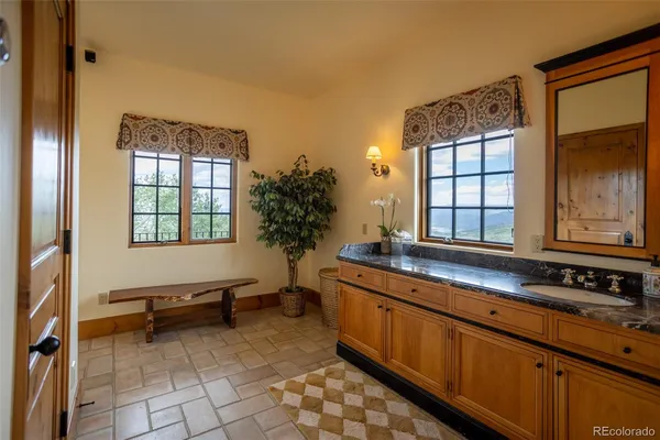 a bathroom with a sink window and mirror