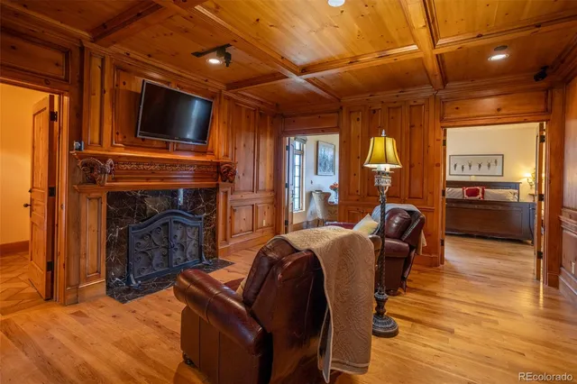 a media room with lots of chairs and a chandelier