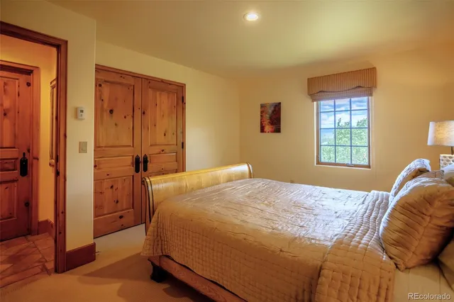 a bed sitting in a room next to a window