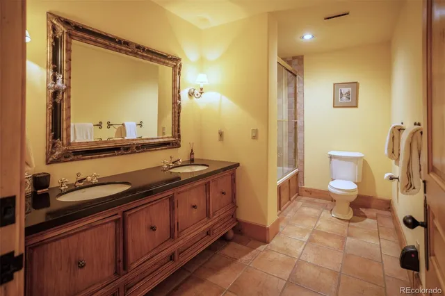 a bedroom with a bed and a night stand