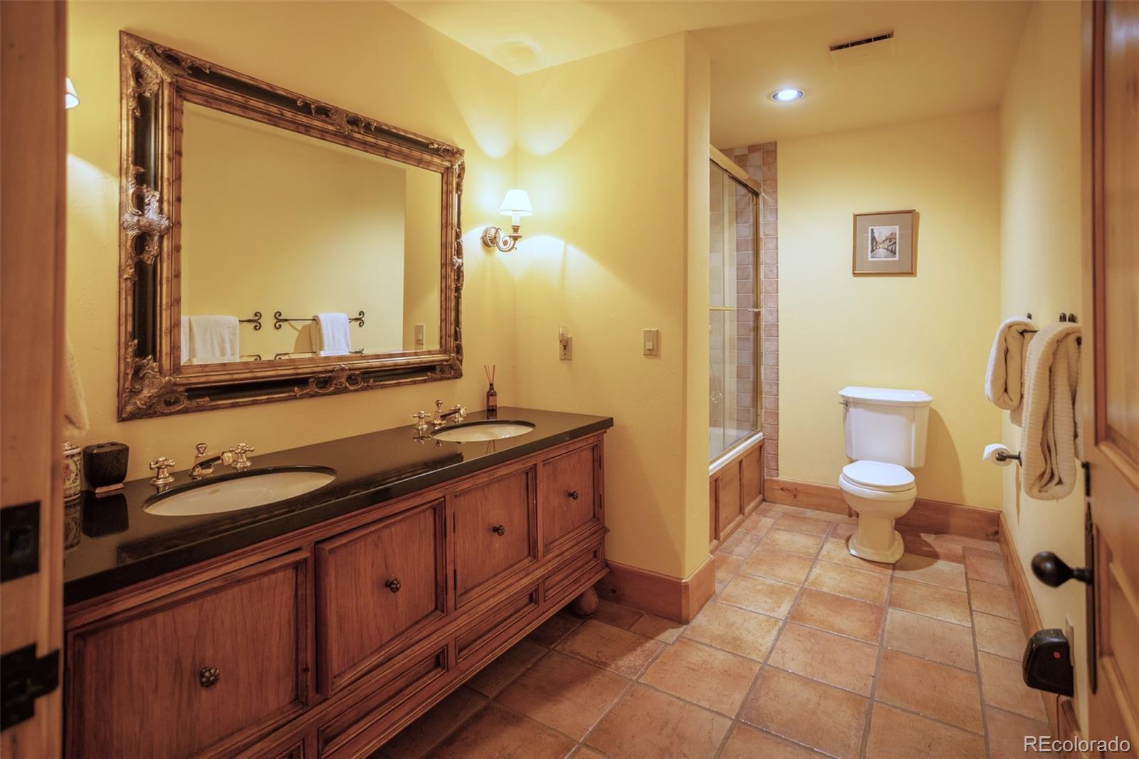 6903 Bellyache Ridge Road Wolcott, CO 81655 - Photo 37 of 50 a bathroom with a double vanity sink and mirror with toilet