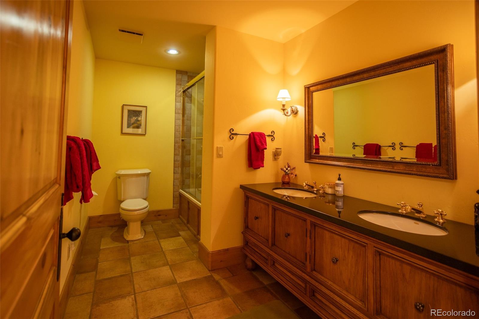6903 Bellyache Ridge Road Wolcott, CO 81655 - Photo 40 of 50 a bathroom with a sink mirror vanity and toilet