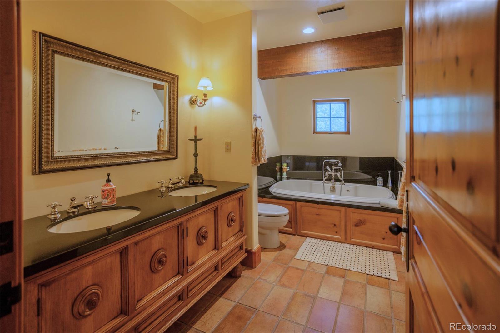 6903 Bellyache Ridge Road Wolcott, CO 81655 - Photo 42 of 50 a spacious bathroom with a double vanity sink and a mirror