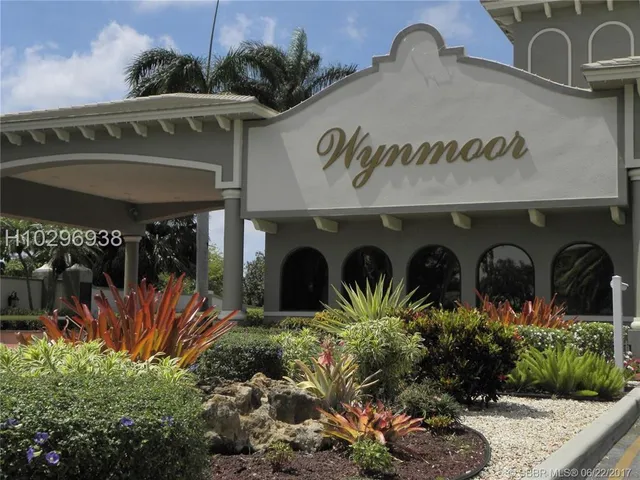 a kitchen with stainless steel appliances granite countertop a sink and a refrigerator