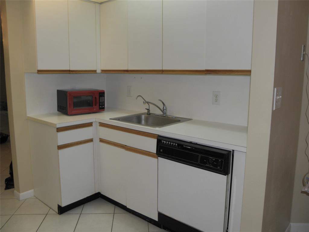 1605 Abaco Drive, Unit 1605 J1 Coconut Creek, FL 33066 - Photo 18 of 71 a kitchen with a sink and a microwave