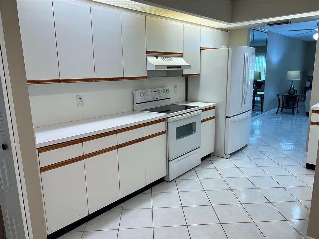 1605 Abaco Drive, Unit 1605 J1 Coconut Creek, FL 33066 - Photo 2 of 71 a kitchen with stainless steel appliances granite countertop a sink and a refrigerator