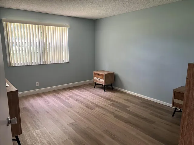 a view of walk in closet with wooden floor